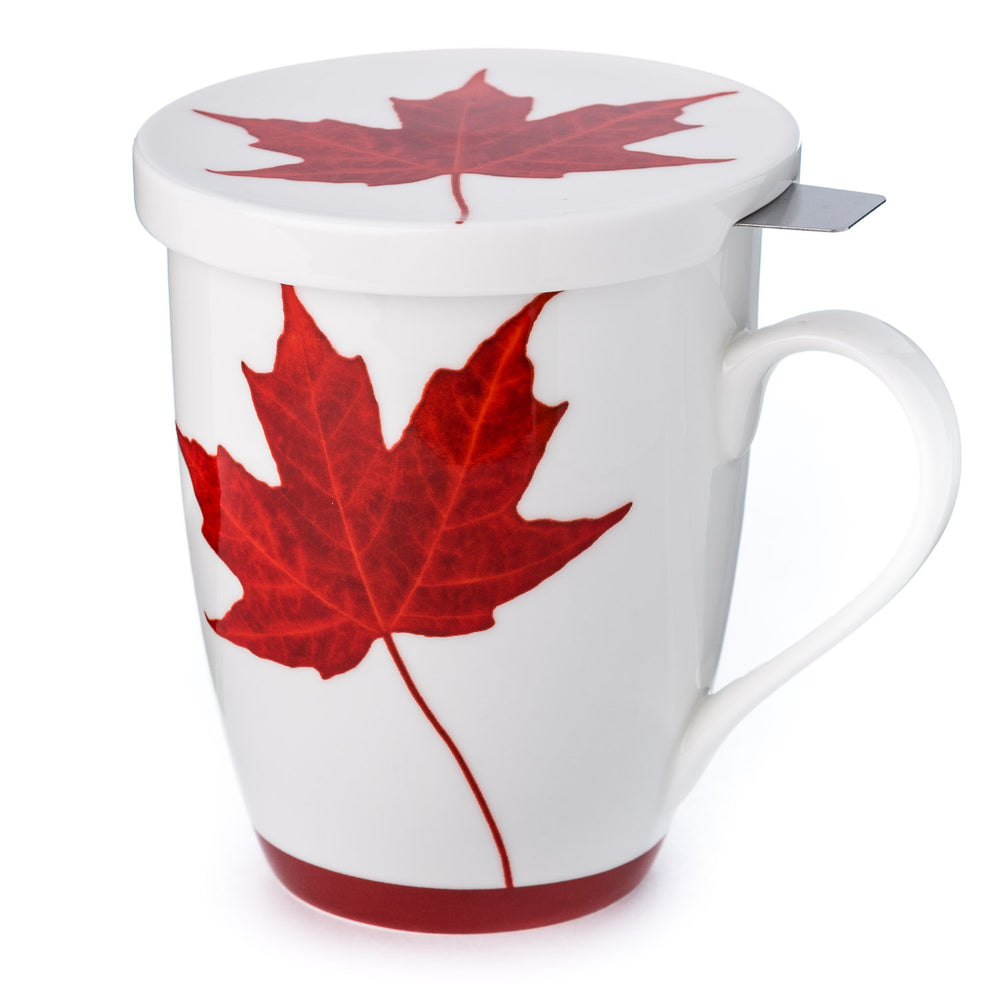 A white fine bone china tea mug and lid with a red maple leaf design and red bottom rim and a stainless steel infuser. 